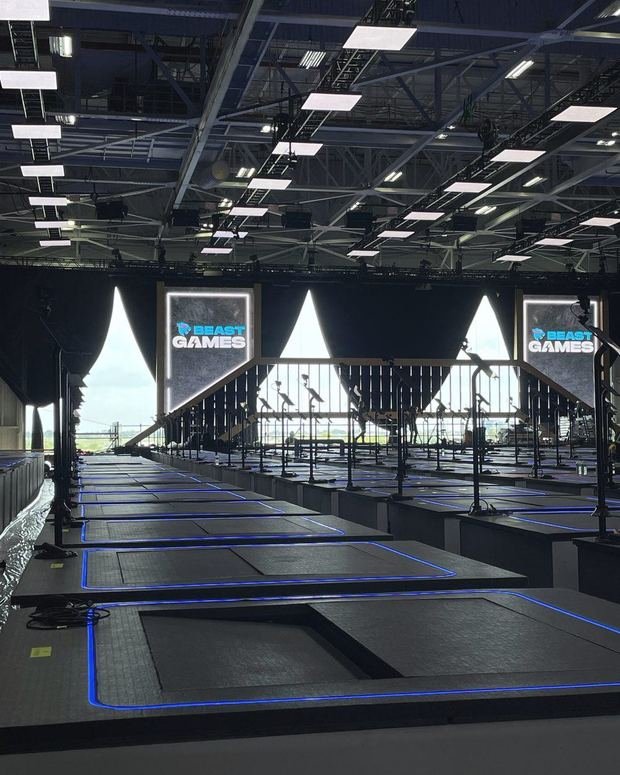 The Beast Games arena with the show logo on screens above the floor